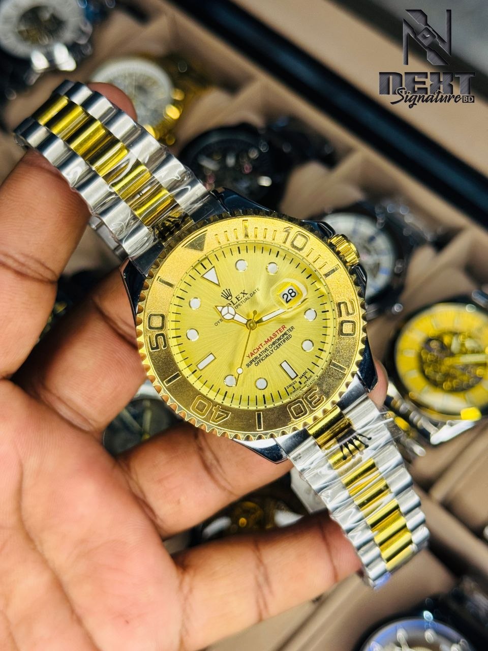 Rolex, Yacht-Master watch with a distinctive green dial and a two-tone gold and steel bracelet.